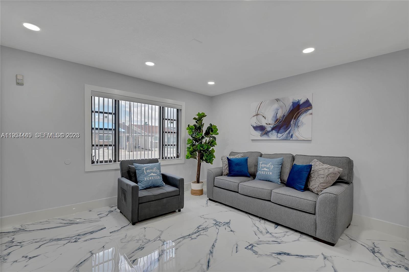 895 West 39th Place, Unit 1 Hialeah, FL 33012 - Photo 3 of 35 a living room with furniture and a large window