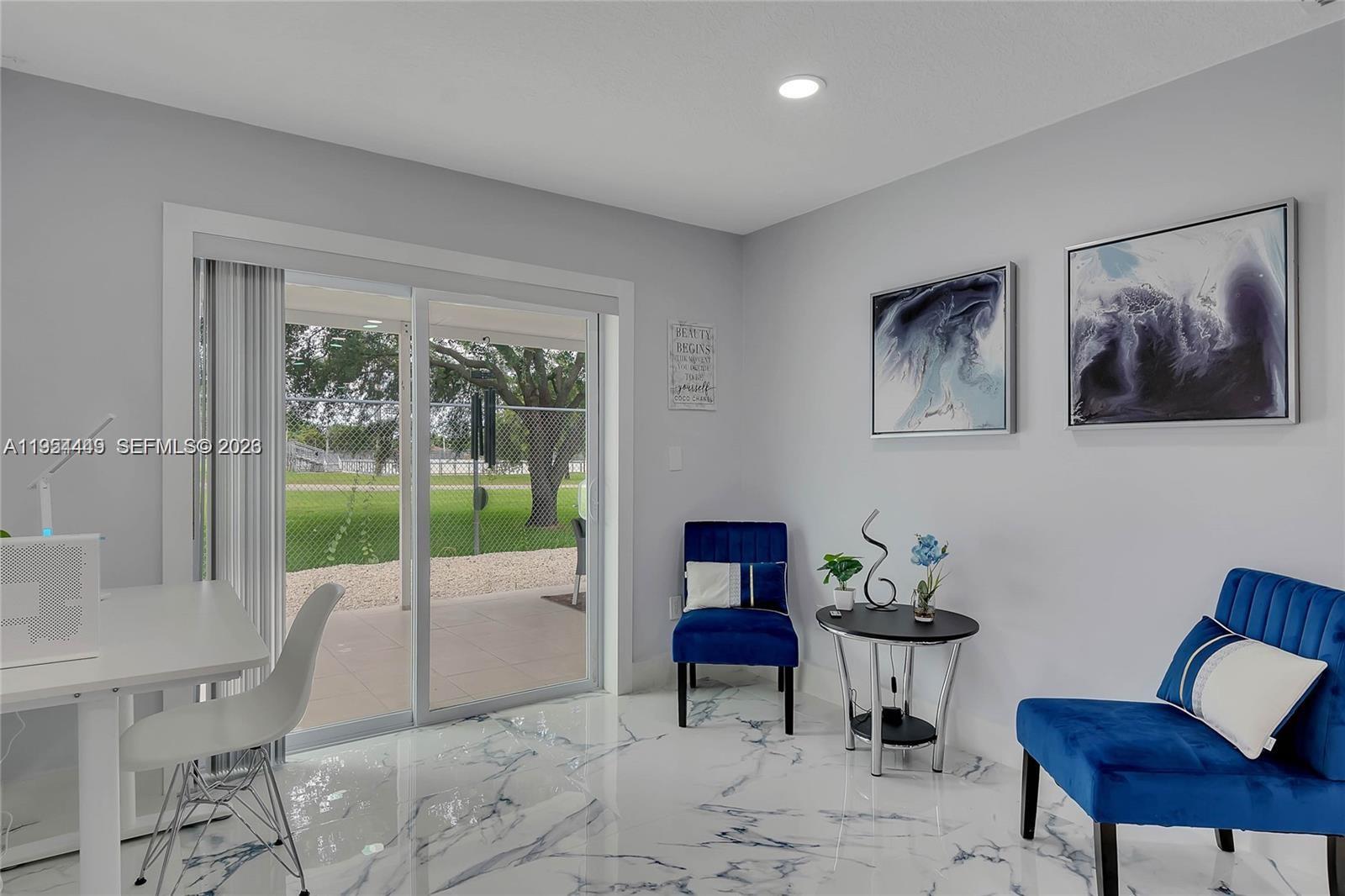 895 West 39th Place, Unit 1 Hialeah, FL 33012 - Photo 5 of 35 a living room with furniture and a large window