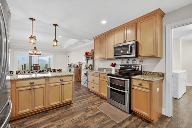 a kitchen with a sink cabinets and wooden floor