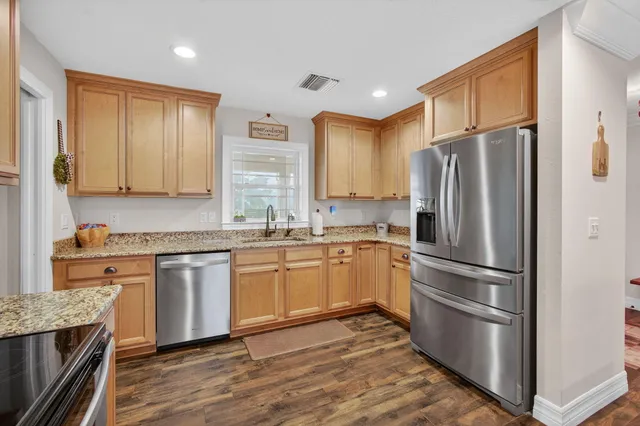 a dining room with furniture window and wooden floor