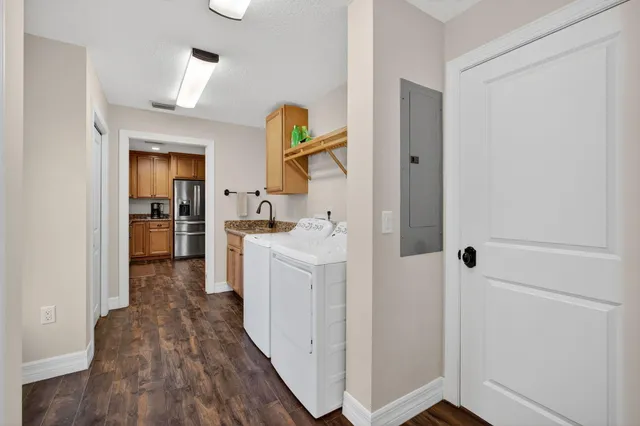 a view of a dining room with furniture a chandelier and wooden floor