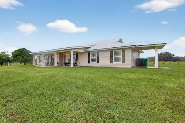 a view of a house with backyard porch and sitting area