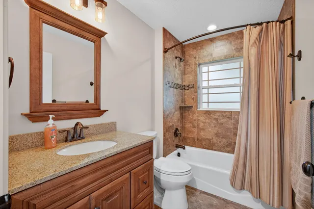 a view of porch with a table and chairs