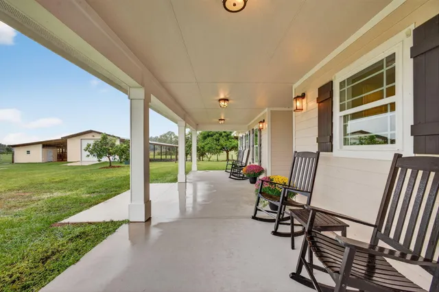 a view of a patio with chairs and a table