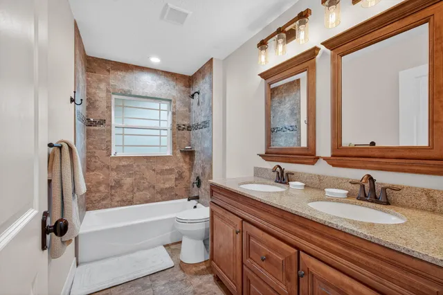 a aerial view of a house with a yard table and chairs