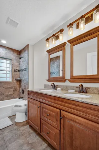 an aerial view of a house with a garden and trees