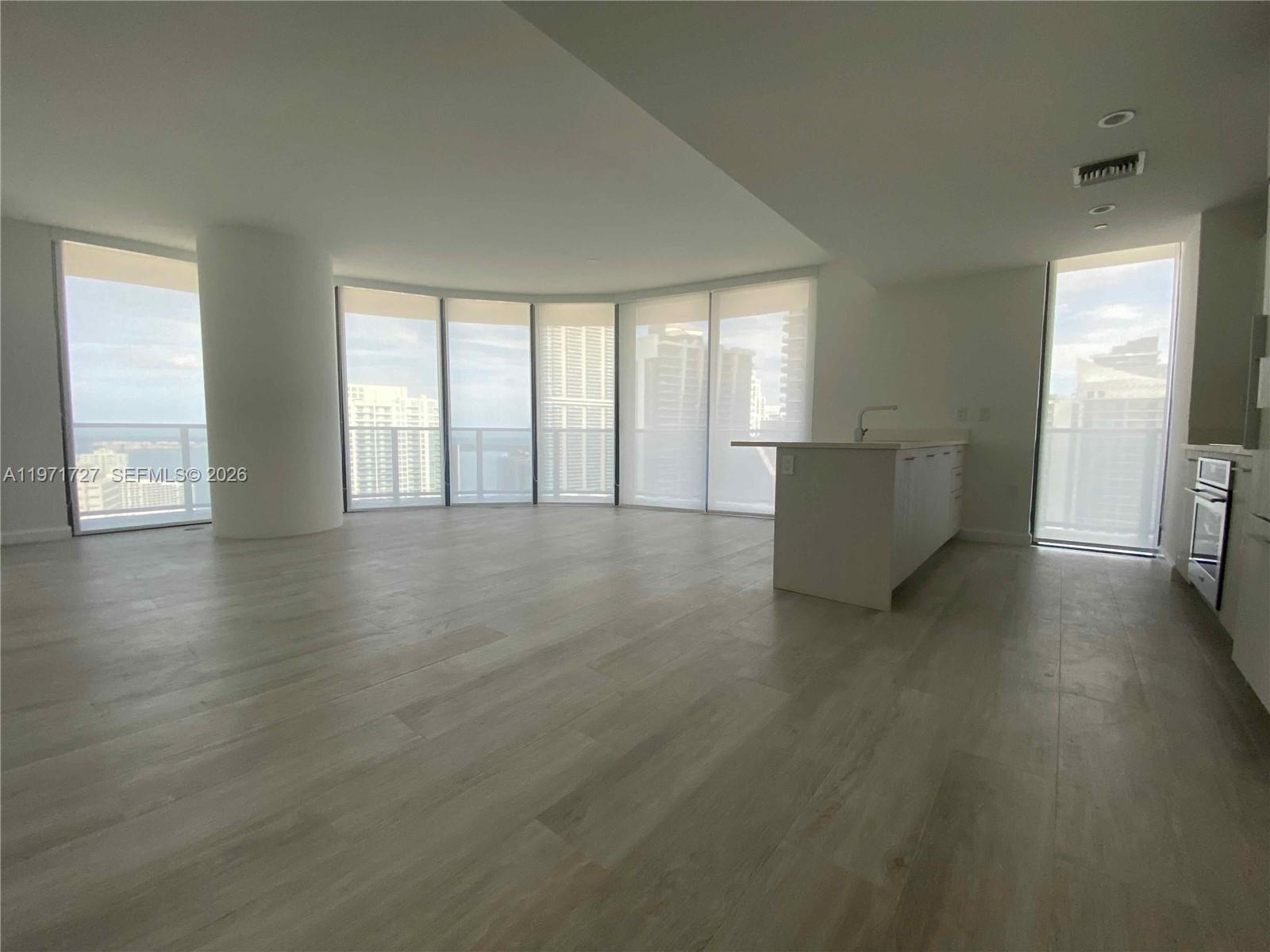 45 Southwest 9th Street, Unit 3703 Miami, FL 33130 - Photo 15 of 73 an empty room with wooden floor and windows