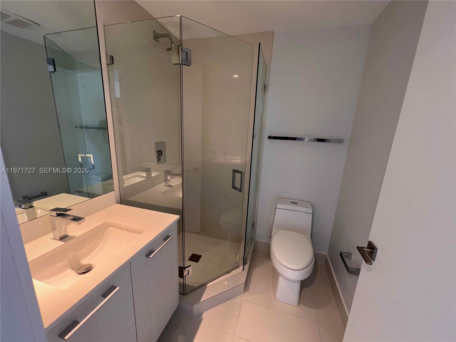 45 Southwest 9th Street, Unit 3703 Miami, FL 33130 - Photo 28 of 73 a bathroom with a sink a toilet and shower