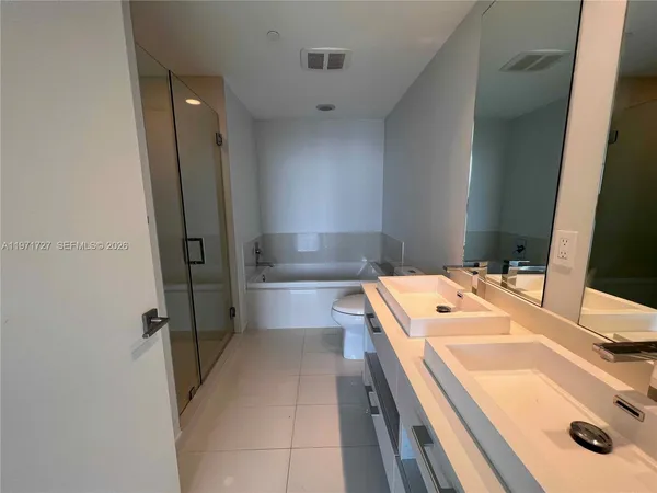 an empty room with wooden floor and closet