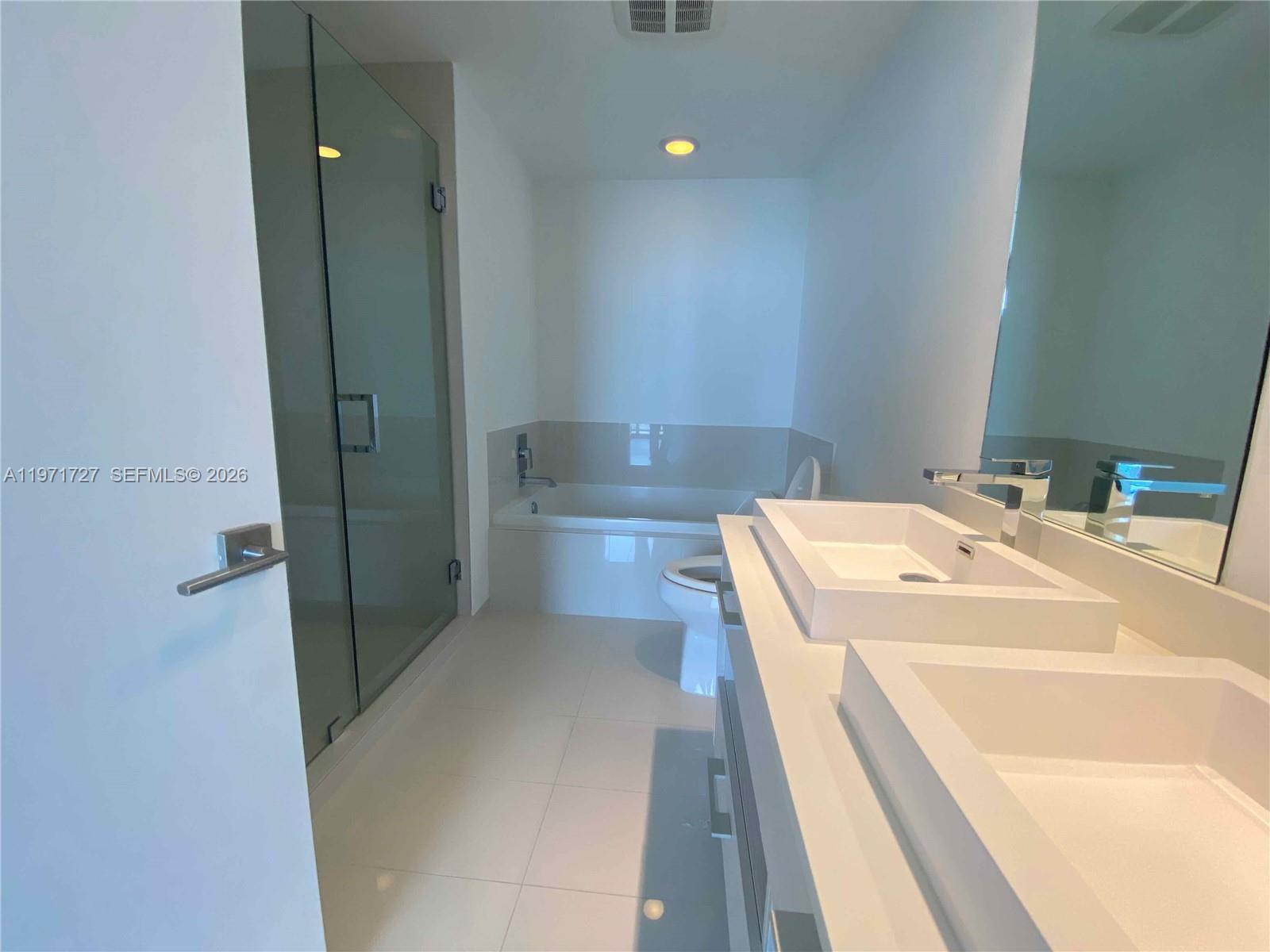 45 Southwest 9th Street, Unit 3703 Miami, FL 33130 - Photo 34 of 73 a bathroom with a sink a toilet and shower