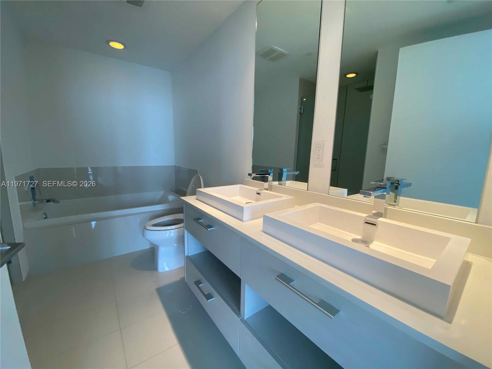 45 Southwest 9th Street, Unit 3703 Miami, FL 33130 - Photo 35 of 73 a bathroom with a sink and a mirror