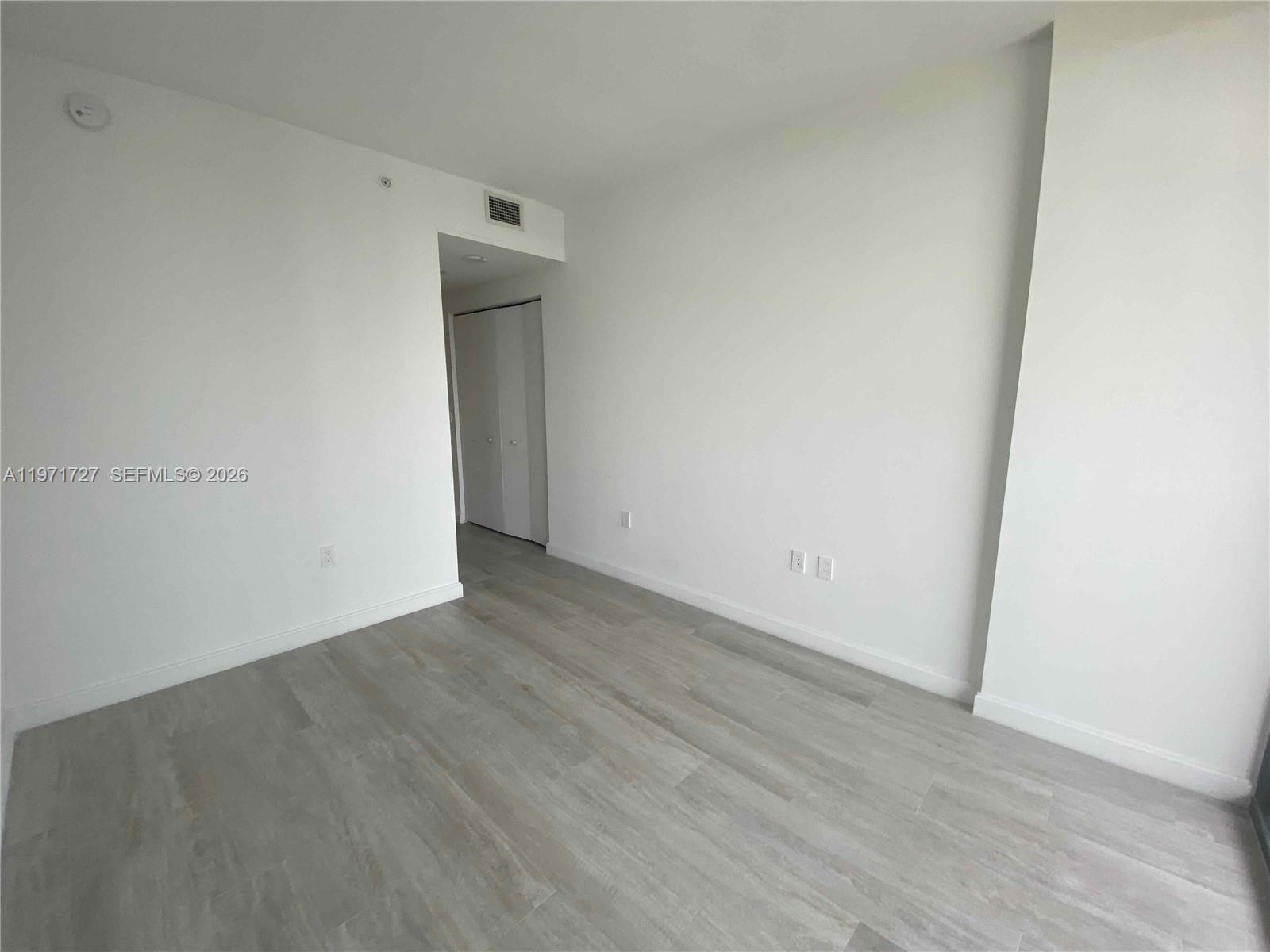 45 Southwest 9th Street, Unit 3703 Miami, FL 33130 - Photo 38 of 73 an empty room with wooden floor and closet