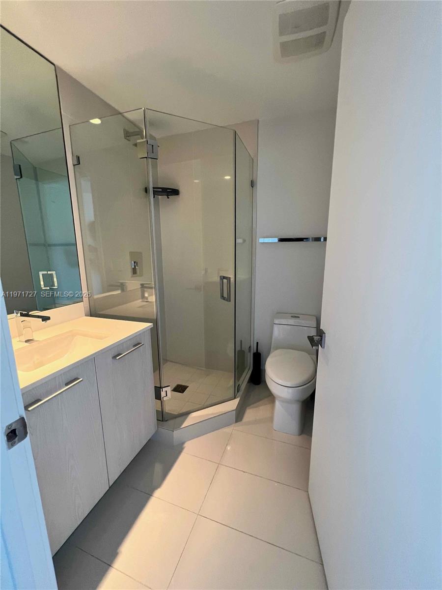 45 Southwest 9th Street, Unit 3703 Miami, FL 33130 - Photo 40 of 73 a bathroom with a sink a toilet and shower