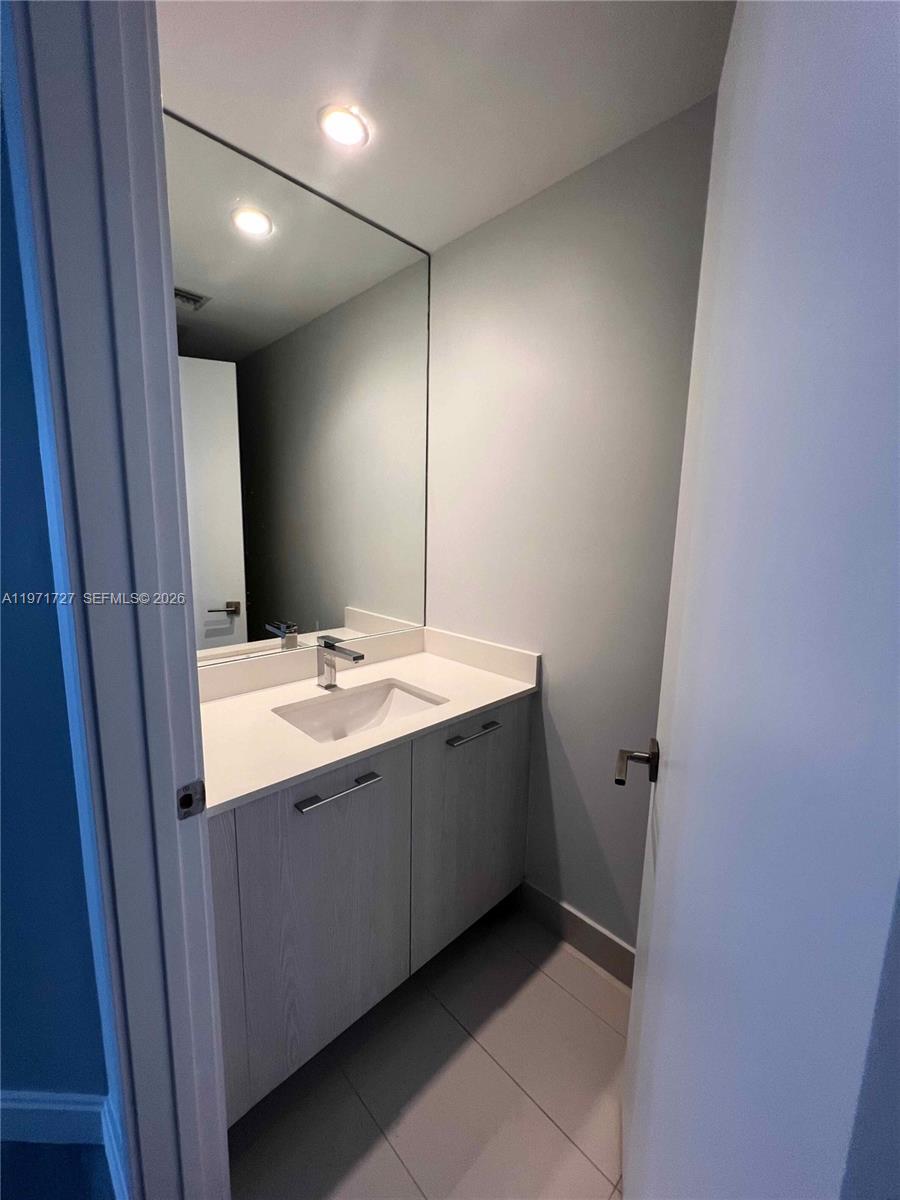 45 Southwest 9th Street, Unit 3703 Miami, FL 33130 - Photo 42 of 73 a bathroom with a sink and mirror