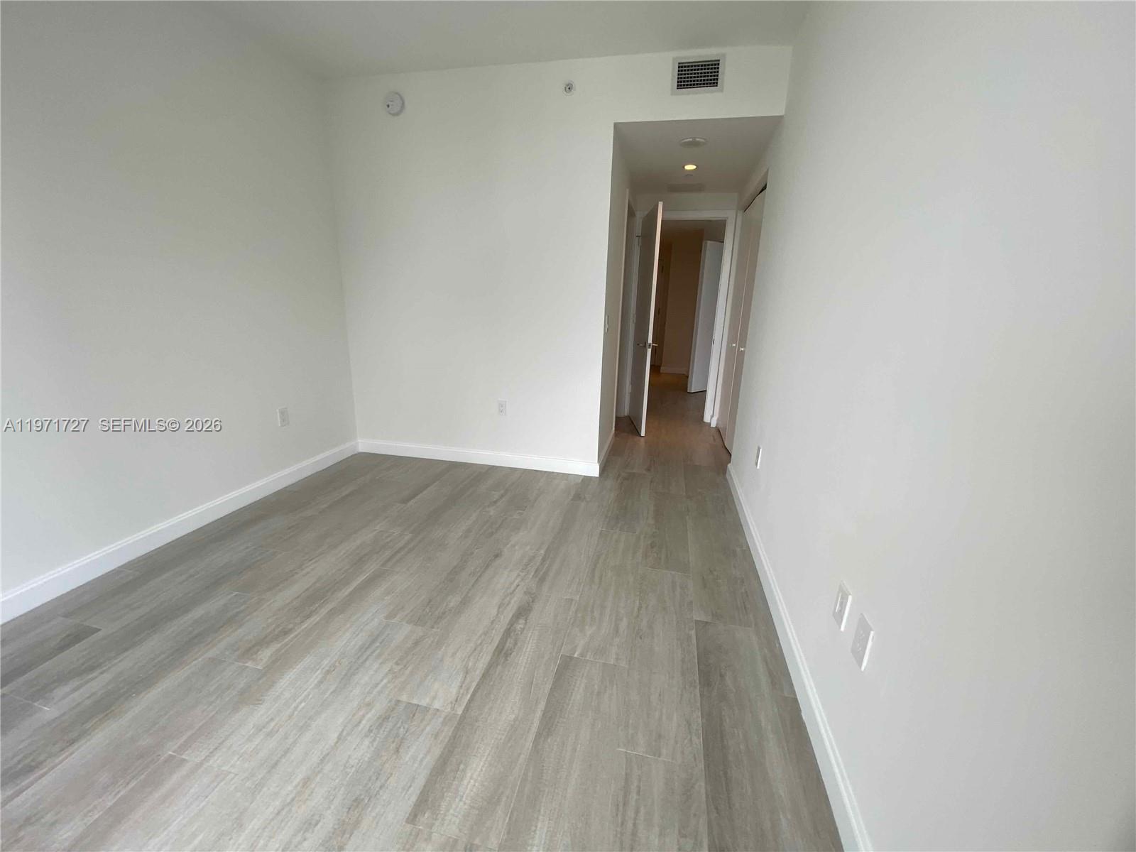 45 Southwest 9th Street, Unit 3703 Miami, FL 33130 - Photo 44 of 73 a view of a hallway with wooden floor