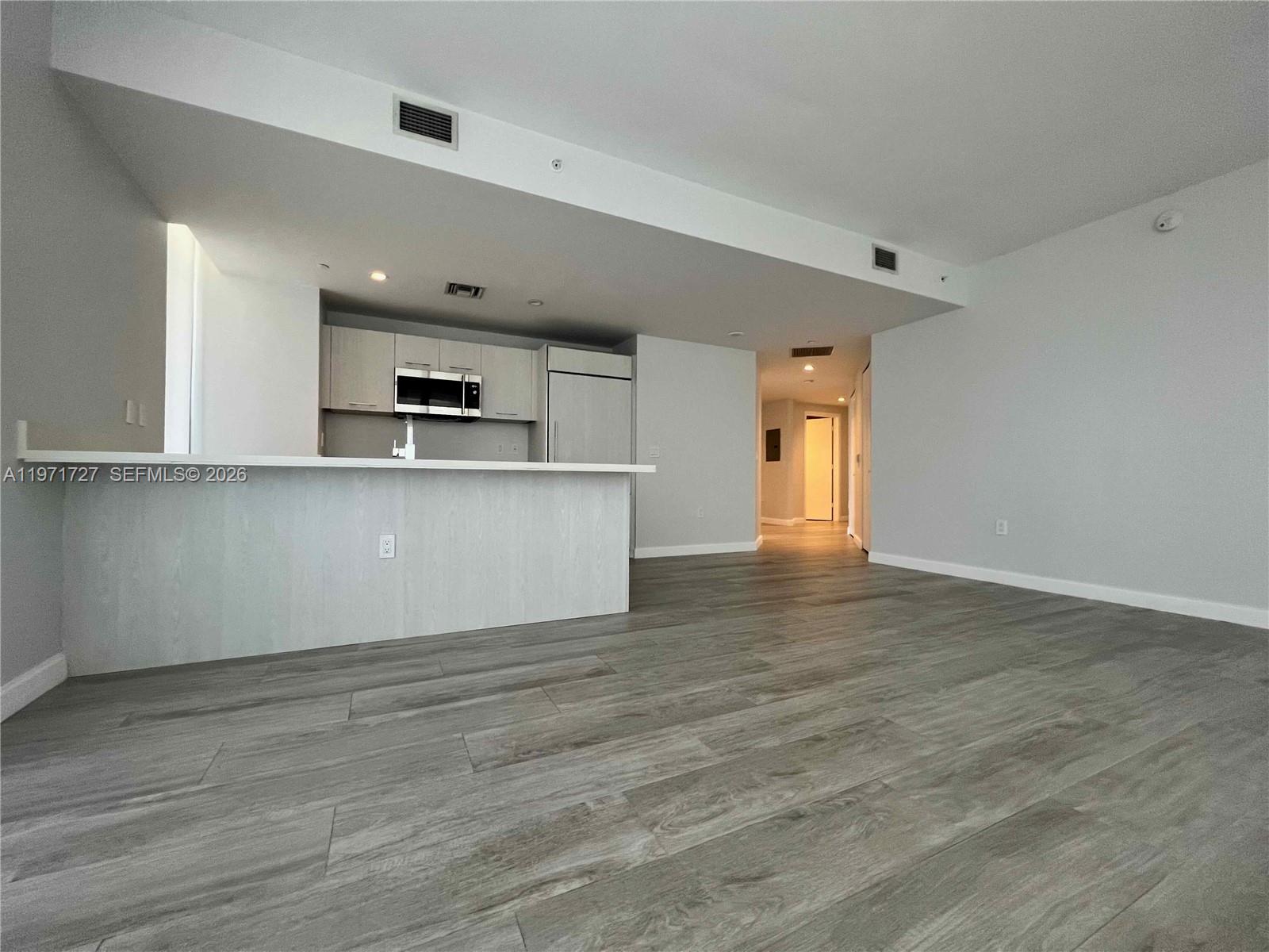 45 Southwest 9th Street, Unit 3703 Miami, FL 33130 - Photo 5 of 73 a view of a kitchen with microwave and cabinets