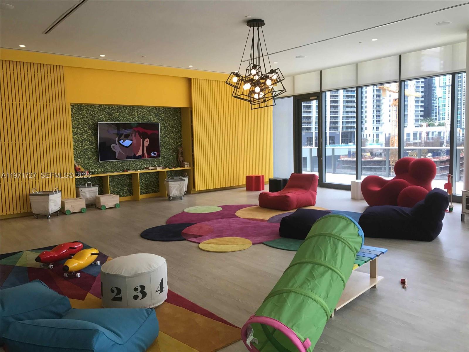 45 Southwest 9th Street, Unit 3703 Miami, FL 33130 - Photo 68 of 73 a living room with furniture and a chandelier