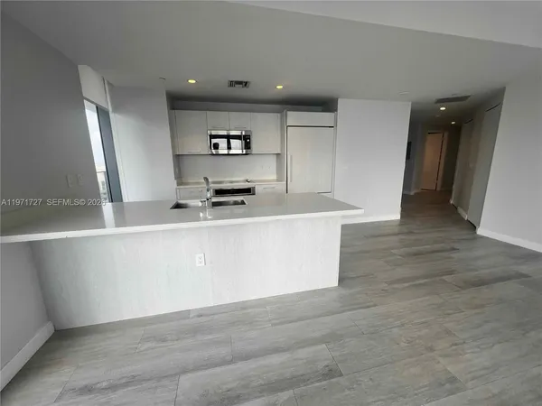 a kitchen with stainless steel appliances a refrigerator sink and cabinets