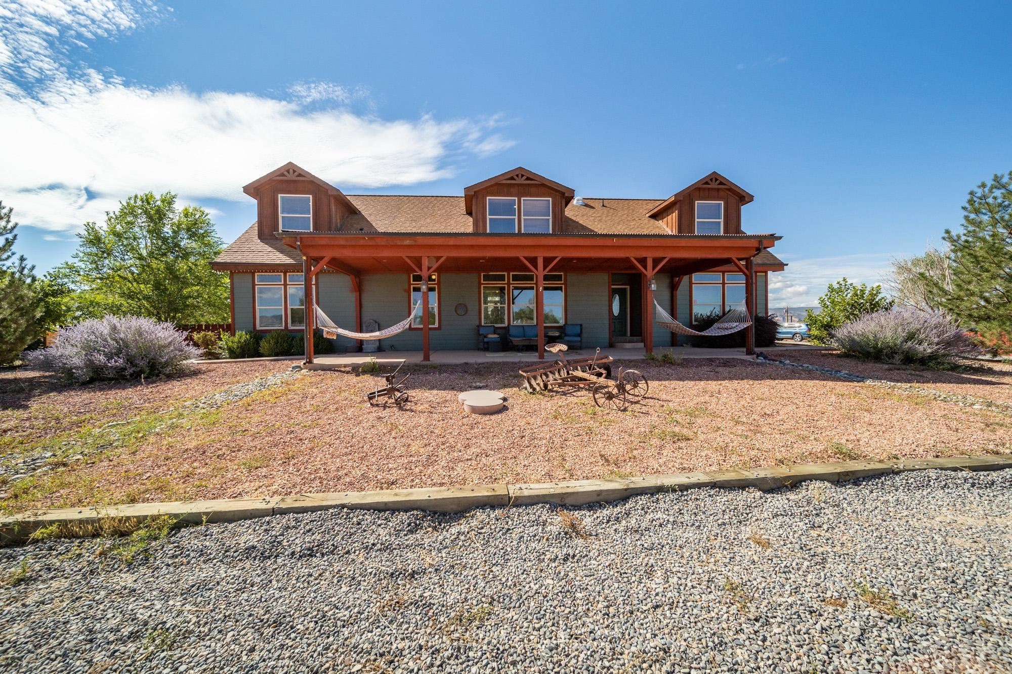 1745 North 3/10 Road Fruita, CO 81521 - Photo 1 of 41 a front view of a house with a yard