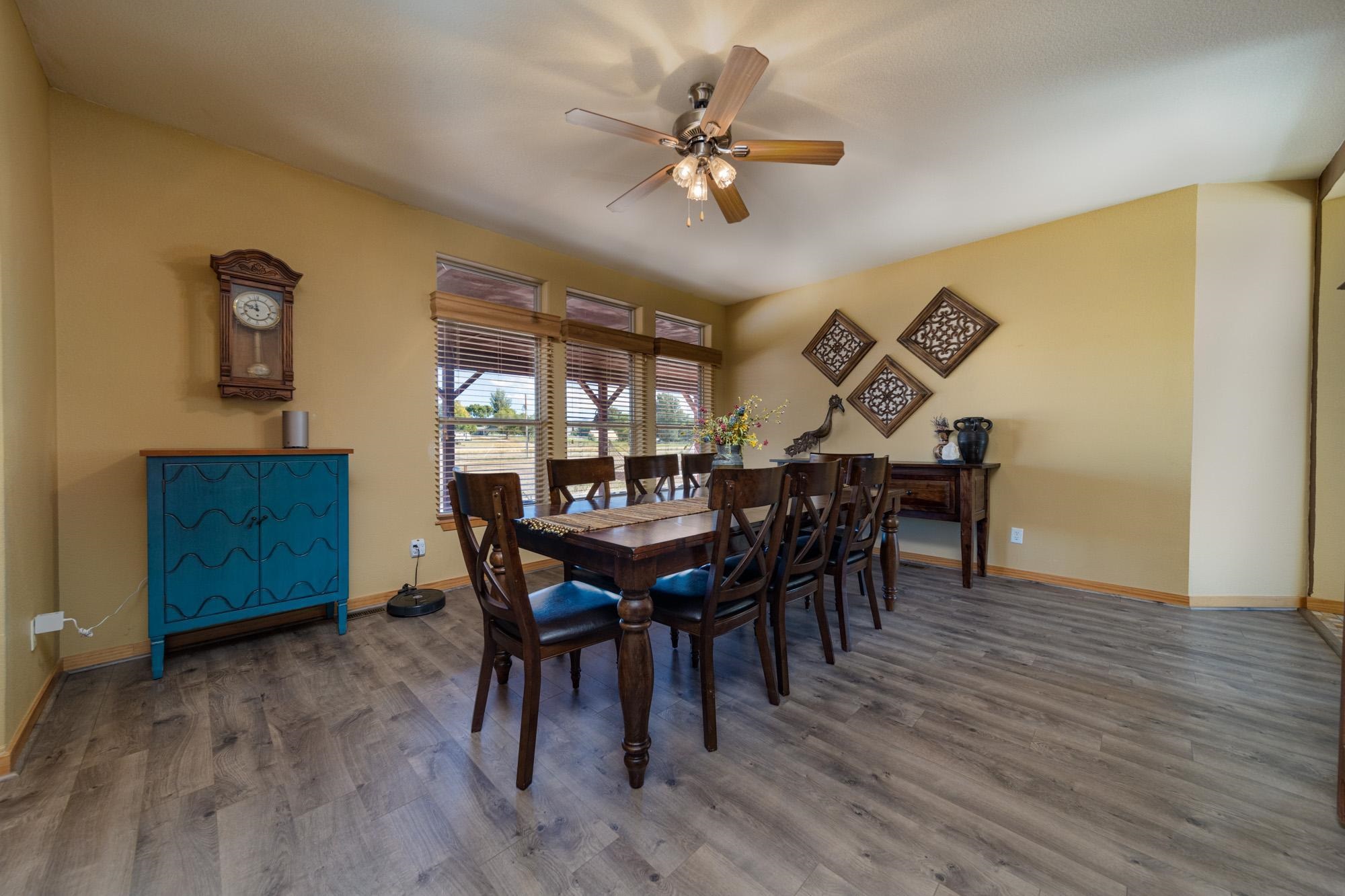 1745 North 3/10 Road Fruita, CO 81521 - Photo 11 of 41 a view of a dining room with furniture and wooden floor