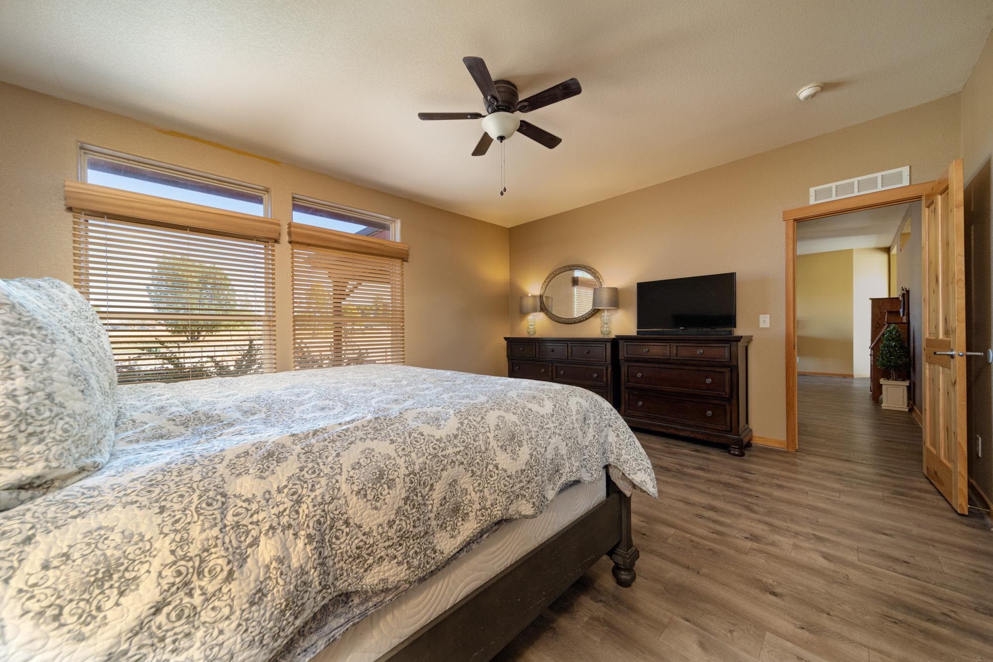 1745 North 3/10 Road Fruita, CO 81521 - Photo 15 of 41 a bedroom with a bed and wooden floor