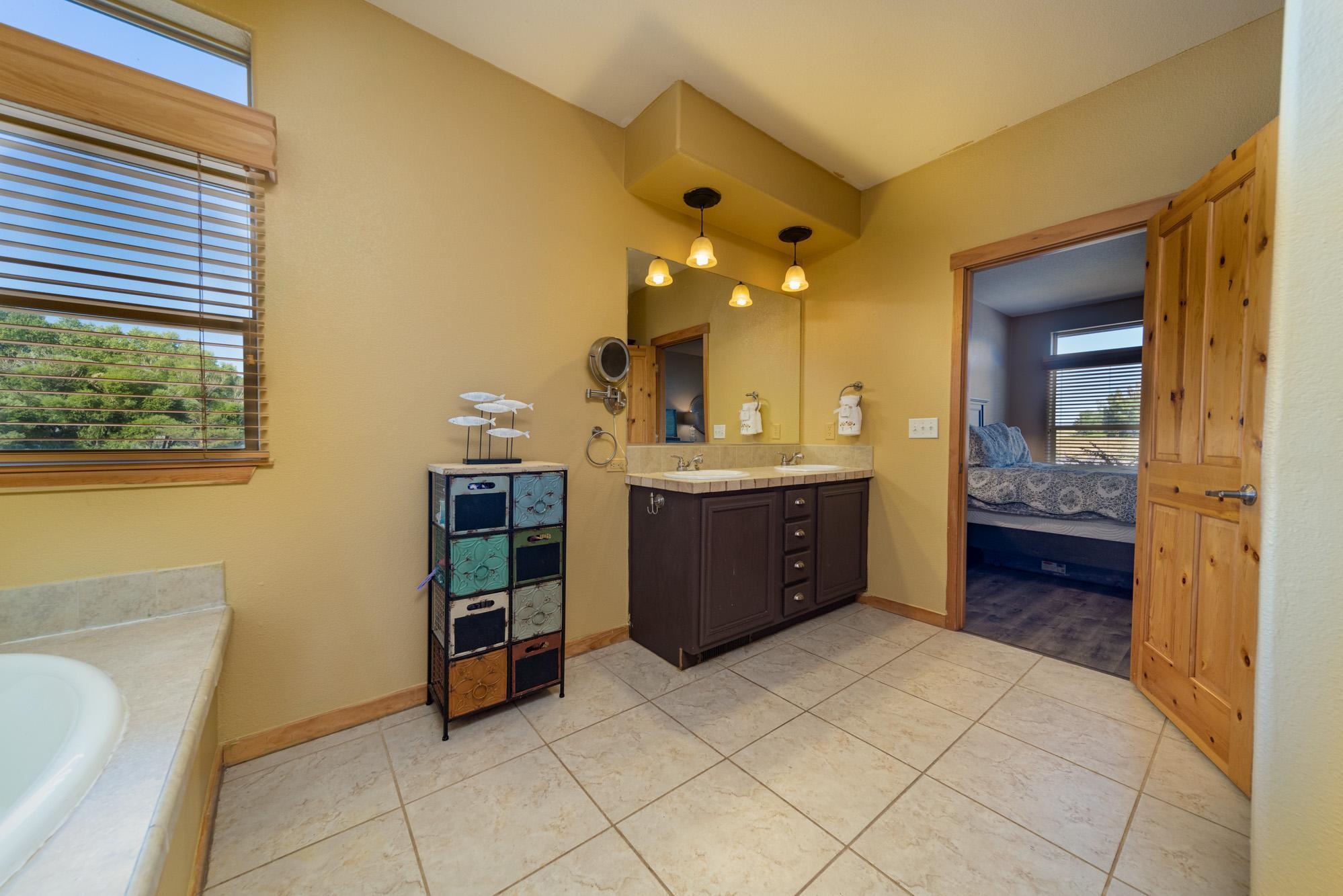 1745 North 3/10 Road Fruita, CO 81521 - Photo 16 of 41 a spacious bathroom with a double vanity sink and a mirror