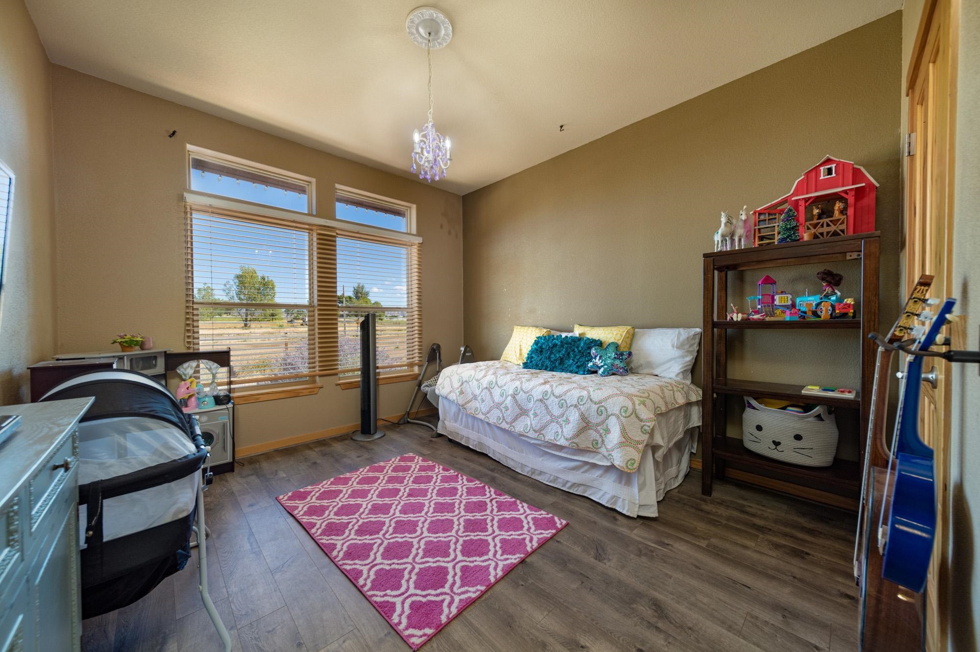 1745 North 3/10 Road Fruita, CO 81521 - Photo 19 of 41 a bedroom with a bed and a window