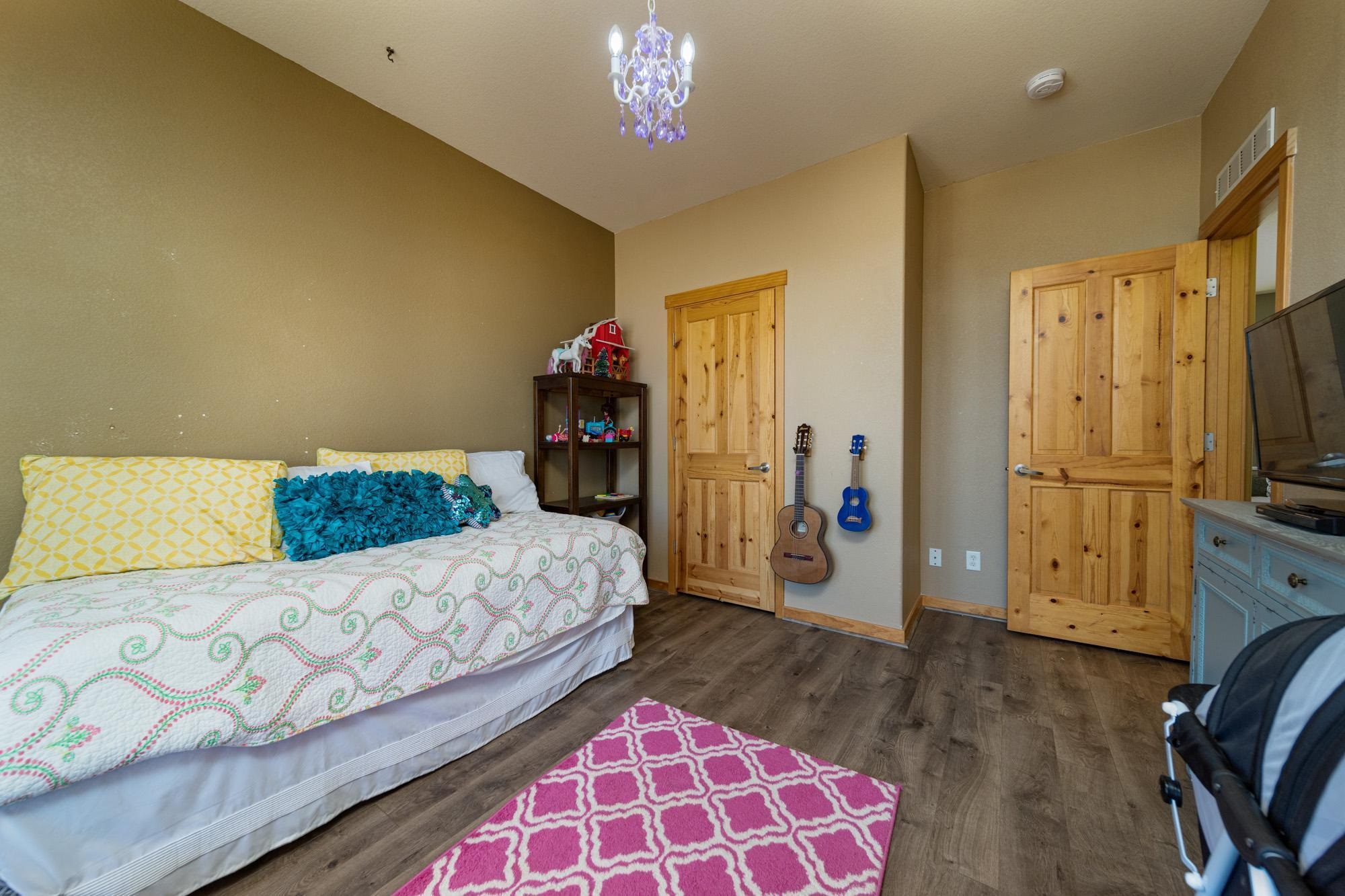1745 North 3/10 Road Fruita, CO 81521 - Photo 20 of 41 a spacious bedroom with a bed and a couch