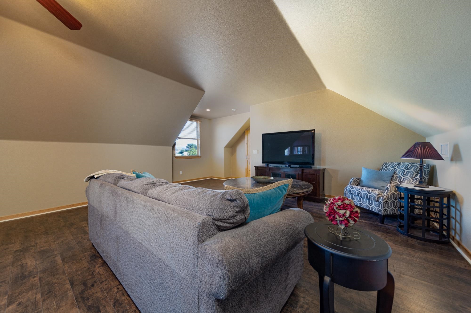 1745 North 3/10 Road Fruita, CO 81521 - Photo 25 of 41 a living room with furniture and a flat screen tv