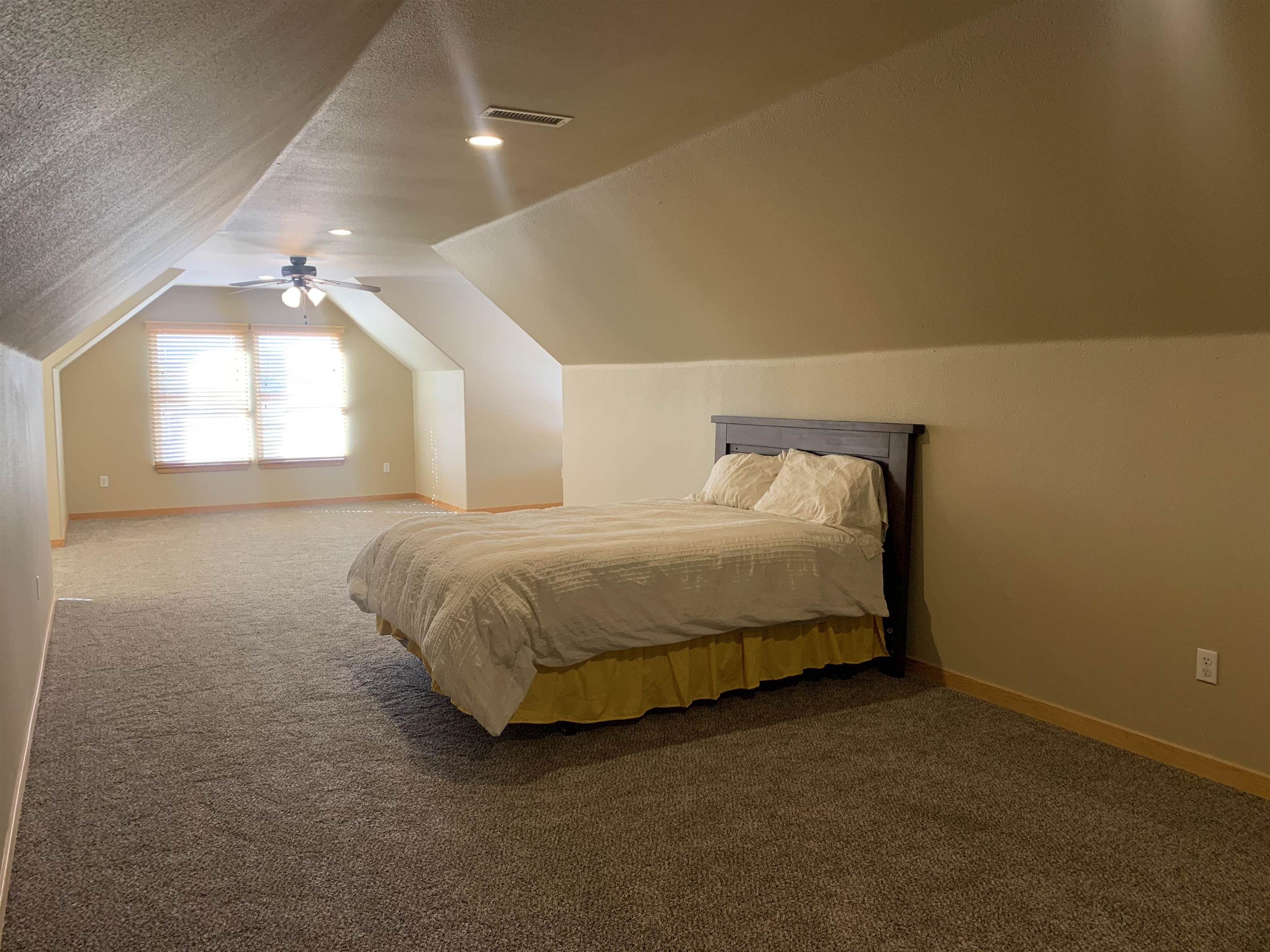 1745 North 3/10 Road Fruita, CO 81521 - Photo 31 of 41 a large bed sitting in a room next to a window
