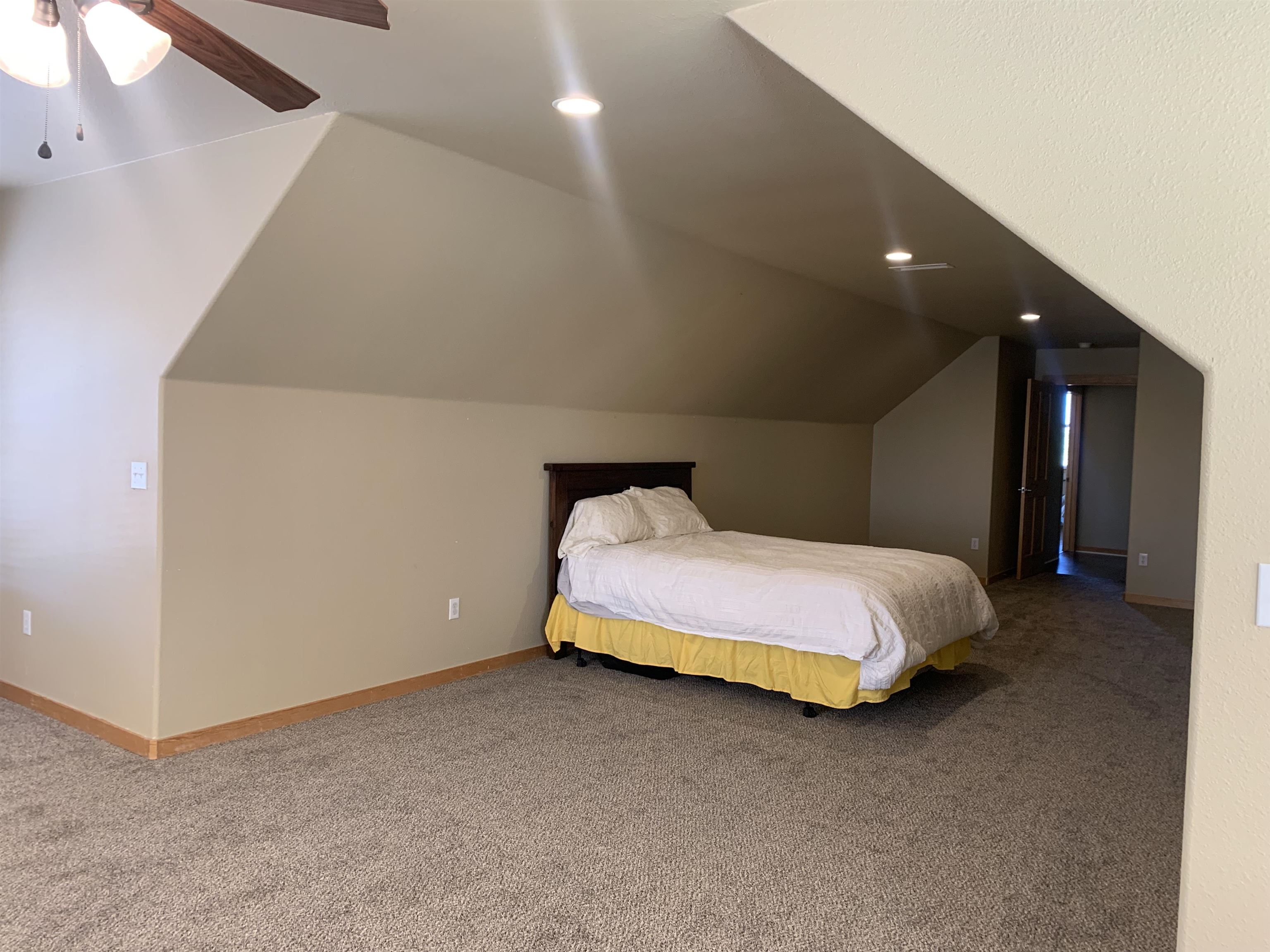 1745 North 3/10 Road Fruita, CO 81521 - Photo 32 of 41 a spacious bedroom with a bed and a night stand