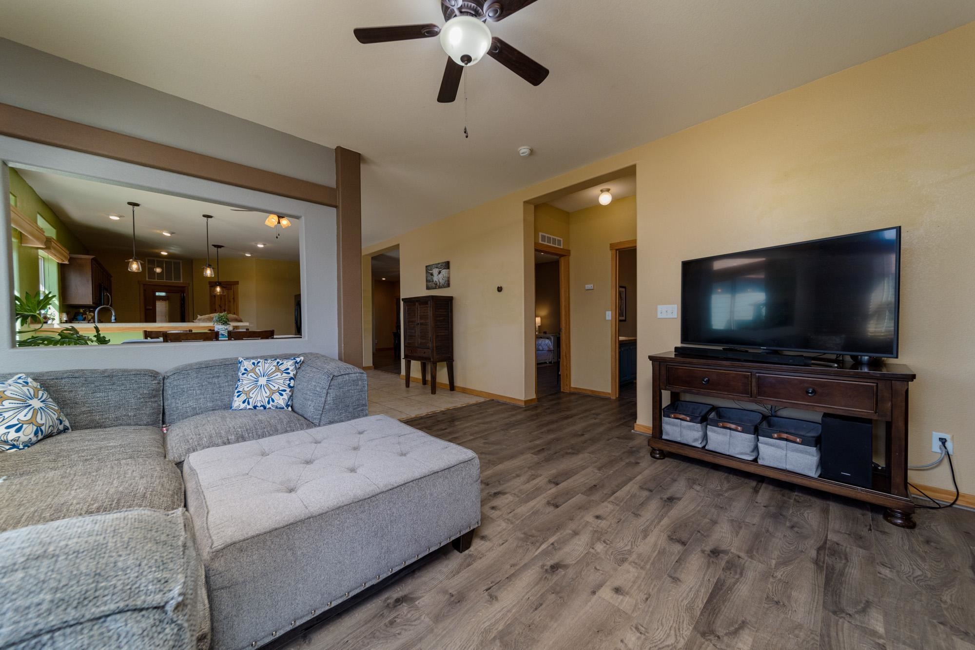 1745 North 3/10 Road Fruita, CO 81521 - Photo 5 of 41 a living room with furniture and a flat screen tv