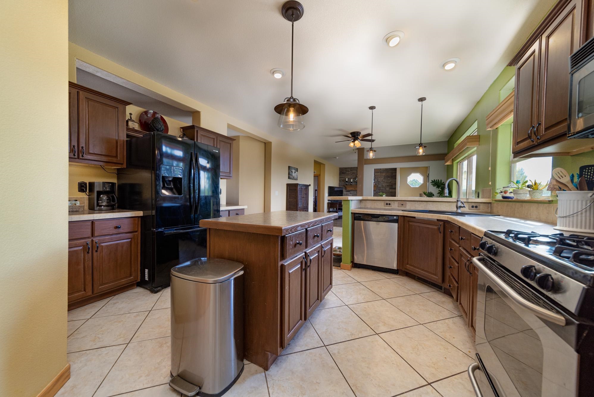 1745 North 3/10 Road Fruita, CO 81521 - Photo 6 of 41 a kitchen with stainless steel appliances granite countertop a stove and a sink