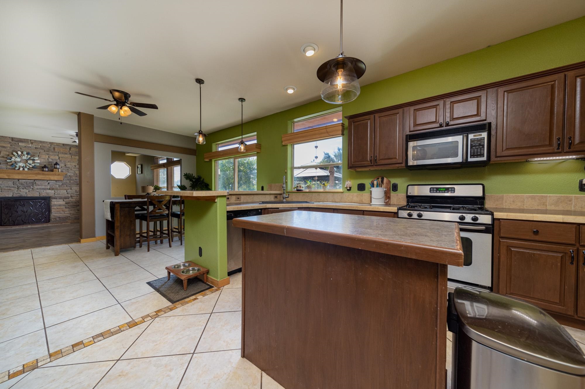 1745 North 3/10 Road Fruita, CO 81521 - Photo 9 of 41 a kitchen with a sink stainless steel appliances and cabinets