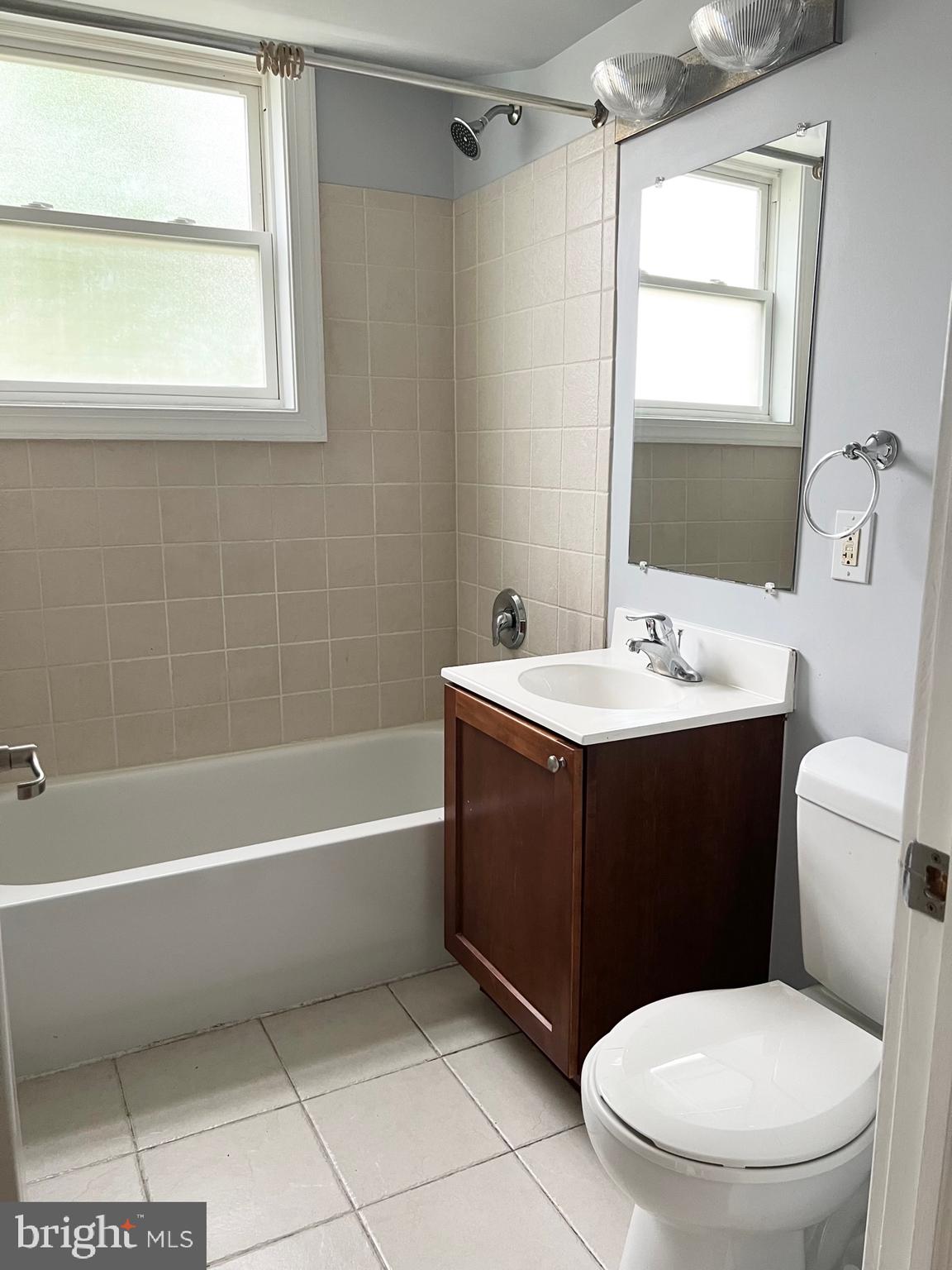 2841 Gainesville Street Southeast, Unit 203 Washington, DC 20020 - Photo 7 of 12 a bathroom with a sink a toilet and shower