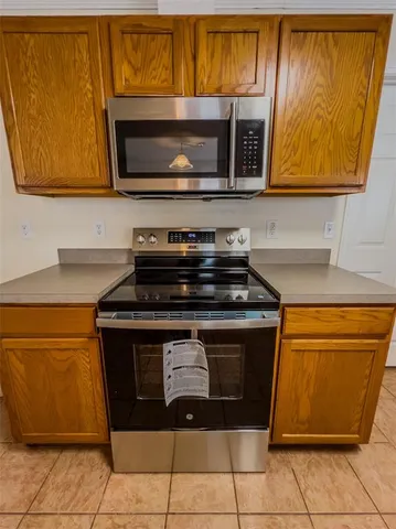 a kitchen with stainless steel appliances granite countertop a sink and a stove