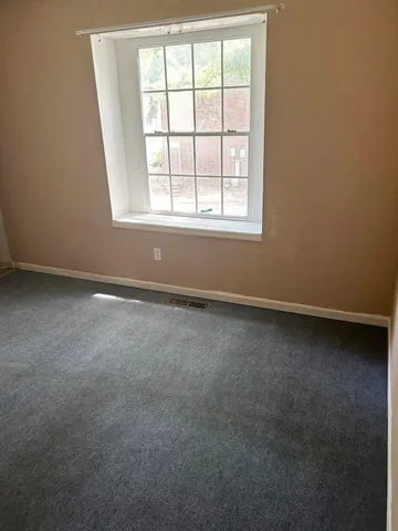 an empty room with a mirror