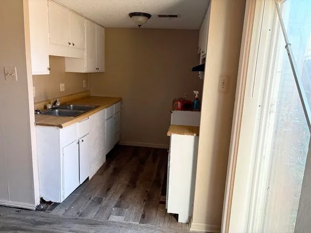a kitchen with cabinets and a stove