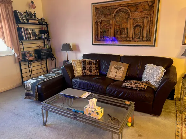 a living room with furniture and a night stand