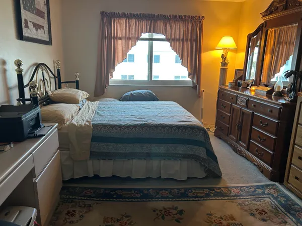a bedroom with a bed next to a window