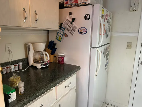 a kitchen with a refrigerator and a stove top oven