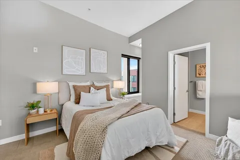 a bed room with a bed and a night stand