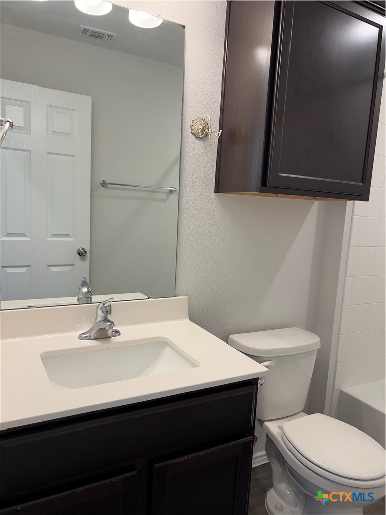 302 Saddleback Trail Killeen, TX 76542 - Photo 27 of 33 a bathroom with a sink a toilet and mirror