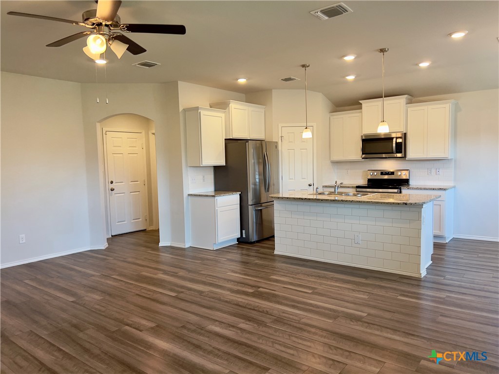 302 Saddleback Trail Killeen, TX 76542 - Photo 7 of 33 a view of kitchen with kitchen island wooden floor appliances and cabinets