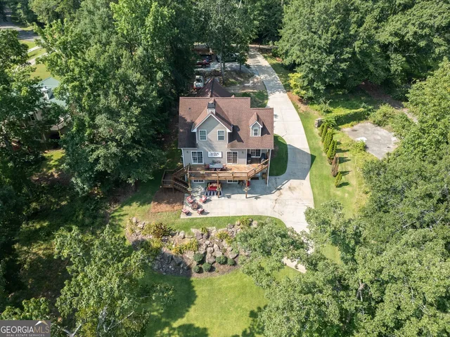 a view of a house with a yard and potted plants