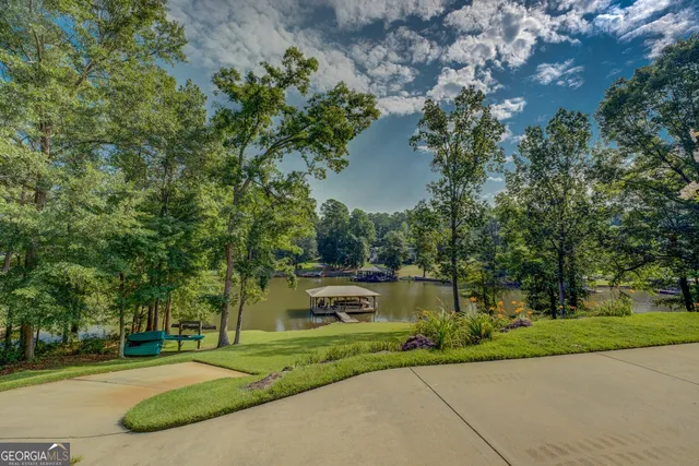 a living room with furniture a clock and a fireplace