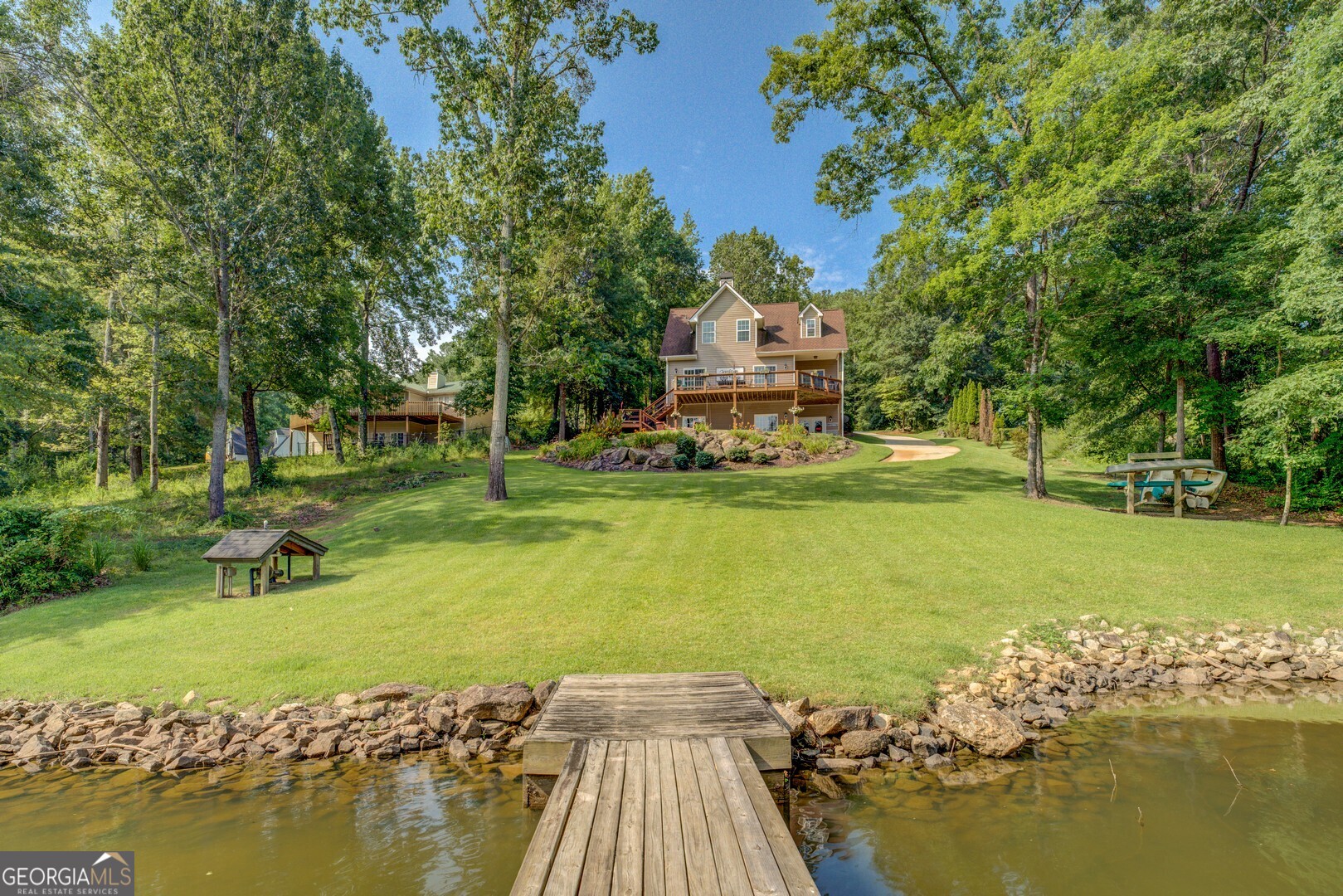 734 Raven Road Monticello, GA 31064 - Photo 26 of 81 a view of a lake with a house swimming pool and outdoor space