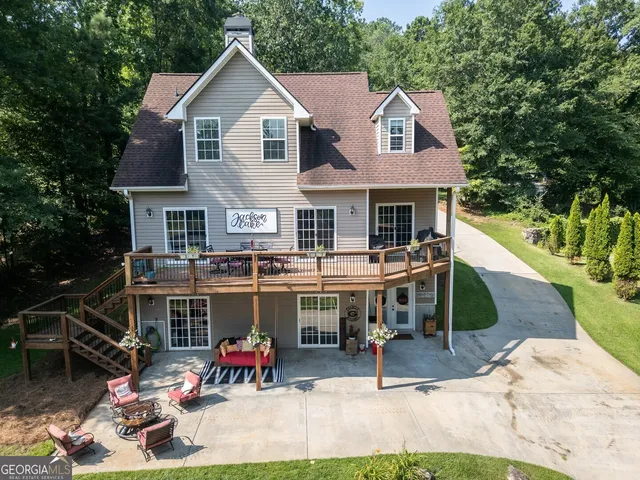 a front view of a house with a yard and trees