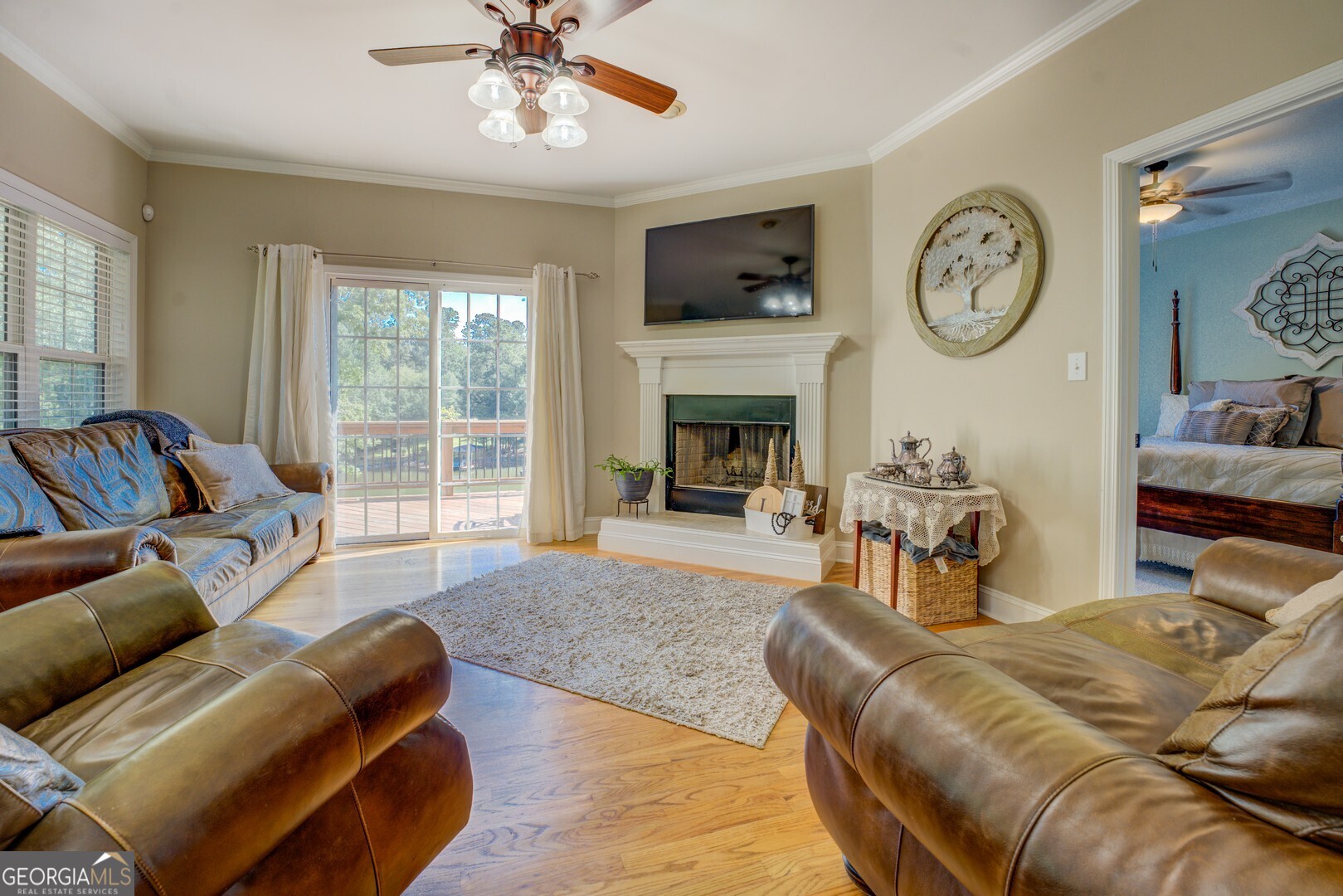 734 Raven Road Monticello, GA 31064 - Photo 31 of 81 a living room with furniture a clock and a fireplace