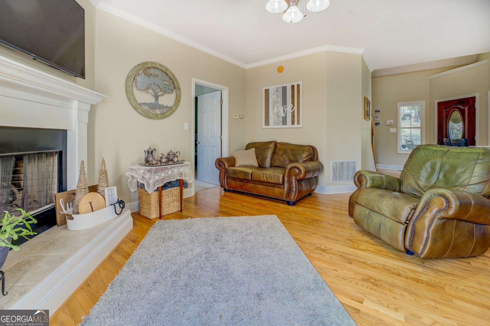 734 Raven Road Monticello, GA 31064 - Photo 34 of 81 a living room with furniture a clock on wall and a window